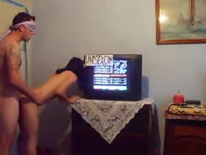 Blindfolded sex by the TV