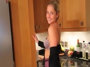 Blonde woman in kitchen teasing hard