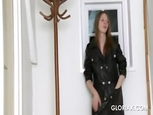 Nasty Gloria in a leather coat posing erotically