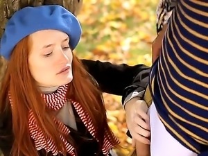 Gorgeous redhead babe with small boobs Denisa Heaven is sucking cock in a park