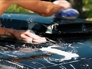 a sensual car wash by a sexy brunette.