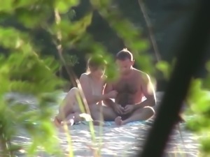 Spying on horny couple having doggy style sex on a beach