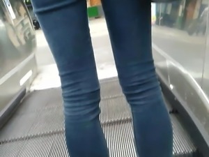 Blue thight jean on a escalator