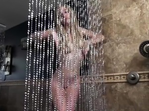 Alluring blonde teen shows off her sexy curves in the shower