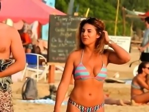 Beach voyeur films a gorgeous young babe in a tight bikini 