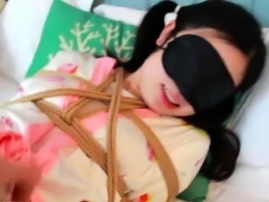 Delightful Oriental teen in costume gets her body tied up