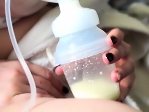Lactating big boobed milf squeezing her milk into a bottle 