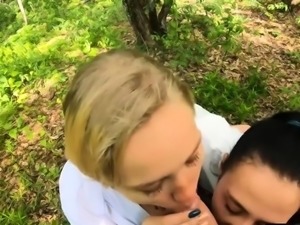 Two Girlfriends Suck Cock in the Wood